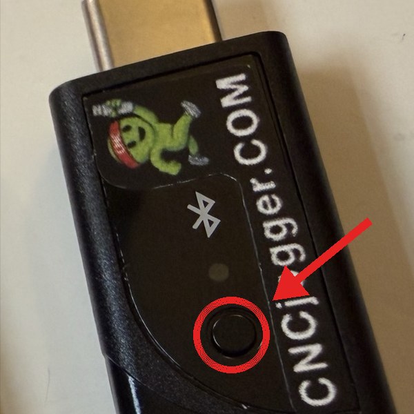 The CNCjogger Stick. The small round button on the side is circled in red.